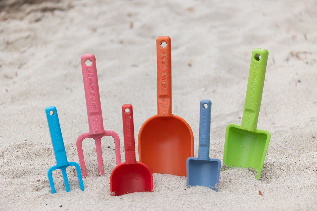 Recycled plastic hand tools for the beach in the sand at beach