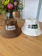 brown-white-kids-size-bucket-hat-sun-protection-sitting-on-bench