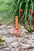 hand-fork-Chicky-kids-tool-orange-garden-view